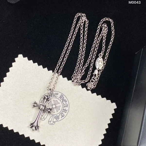 Chrome Hearts cross charm necklace in sterling silver with signature gothic-style detailing.