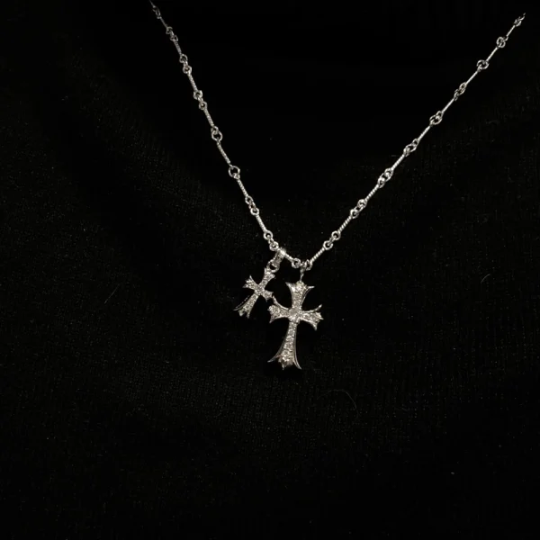 Handcrafted Chrome Hearts necklace featuring two silver crosses, a signature blend of luxury and attitude.