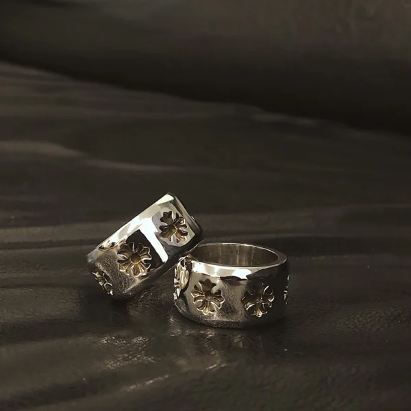 Sterling silver Chrome Hearts ring with thick band and signature CH Plus symbols, handcrafted luxury jewelry.