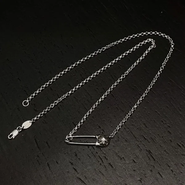 Luxury Chrome Hearts CH safety pin necklace, handcrafted silver jewelry with streetwear appeal.