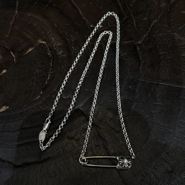 Chrome Hearts CH safety pin necklace in sterling silver with edgy gothic design.