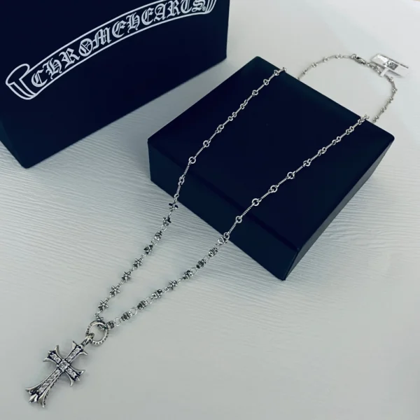Chrome Hearts cross charm necklace in sterling silver adorned with sparkling diamonds.