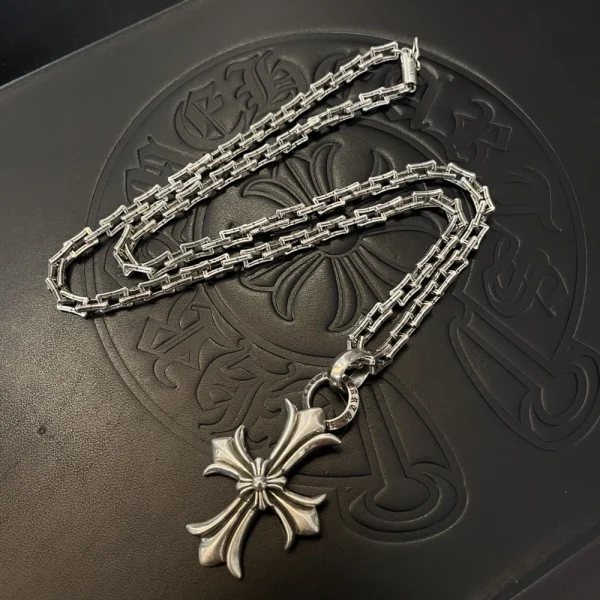 Luxury Chrome Hearts necklace with silver cross charm, perfect for edgy and layered fashion looks.