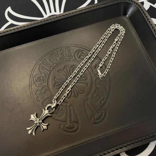 Chrome Hearts cross charm necklace in sterling silver with iconic gothic-style pendant.