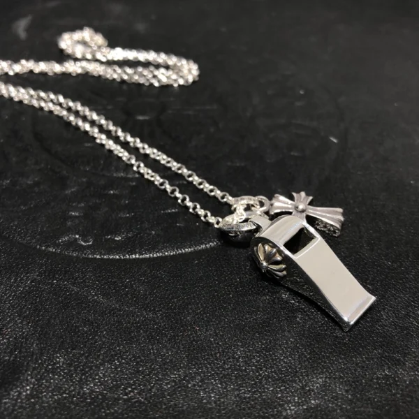 Chrome Hearts filigree cross charm necklace in sterling silver with intricate gothic details.