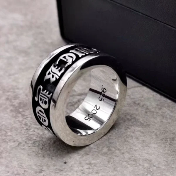 Statement Chrome Hearts spinning ring featuring engraved bold lettering, handcrafted silver jewelry with edgy style.
