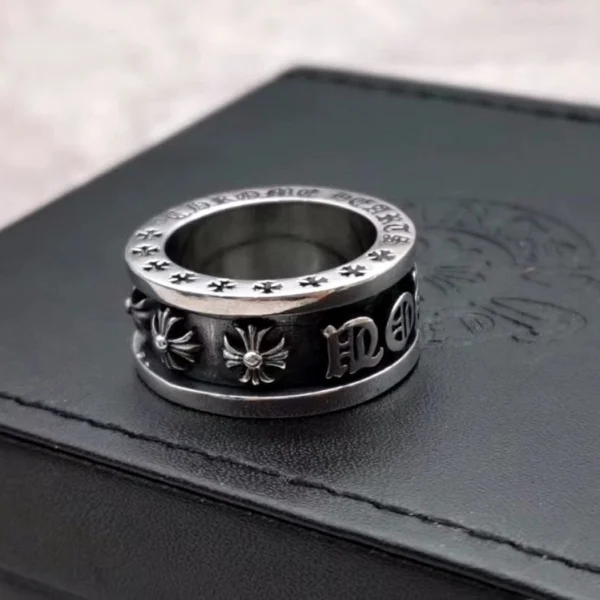 Chrome Hearts edgy spinner ring in sterling silver featuring bold engraved rebellious phrase and gothic design.