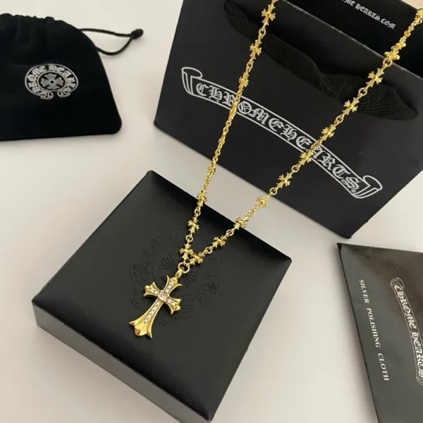 Chrome Hearts gold necklace with diamond-studded pendant, luxury gothic-inspired jewelry.