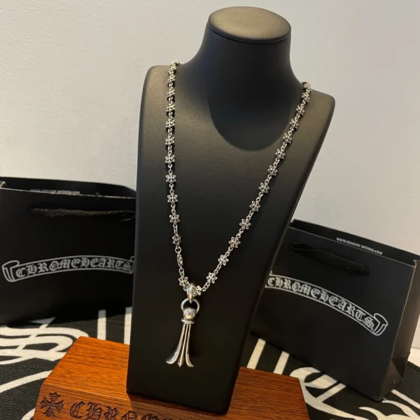 Chrome Hearts-style necklace featuring bold gothic motifs and silver chain design.