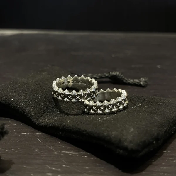 Sterling silver Chrome Hearts ring featuring ragged edge design and signature plus motif.