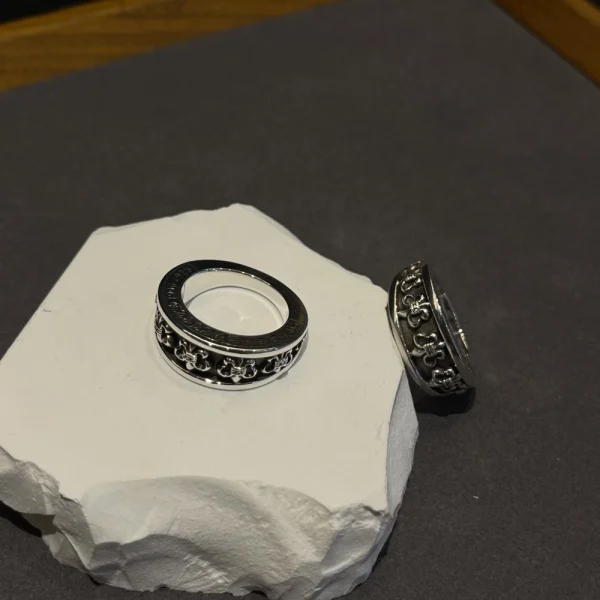 Assorted Chrome Hearts rings with crosses, daggers, fleur-de-lis, and bold silver craftsmanship.
