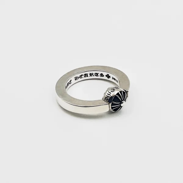 Chrome Hearts spinning cross ring, handcrafted silver band with dynamic movement and iconic design.