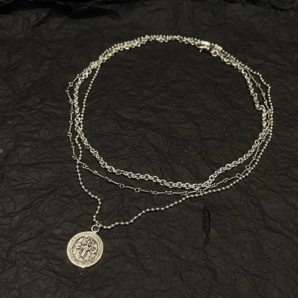 Chrome Hearts Round Angel Medallion charm necklace in sterling silver with detailed engraving.