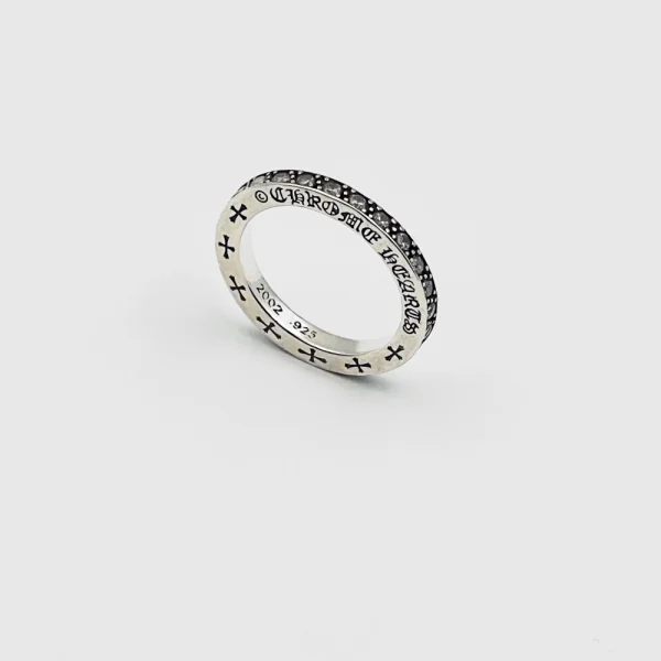Sterling silver Chrome Hearts ring with iconic cross or floral design, combining luxury and streetwear edge.