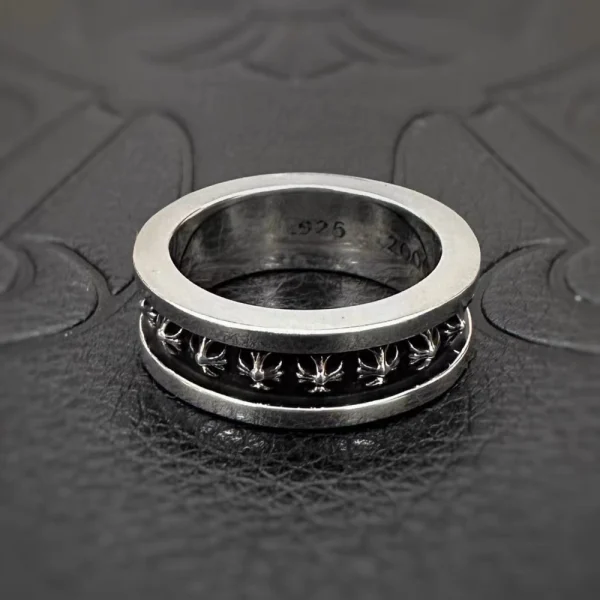 Chrome Hearts Tiny CH Plus spinner ring in sterling silver with rotating band and engraved gothic cross motifs.