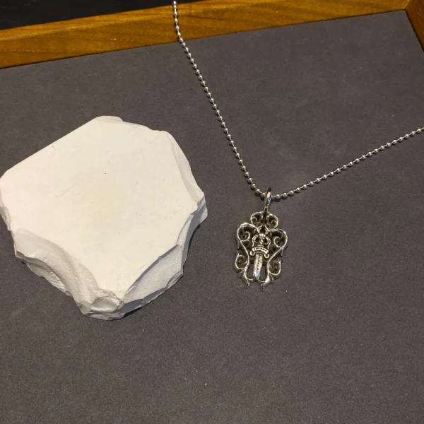 Sterling silver Chrome Hearts necklace featuring Vine Dagger pendant and handcrafted luxury finish.