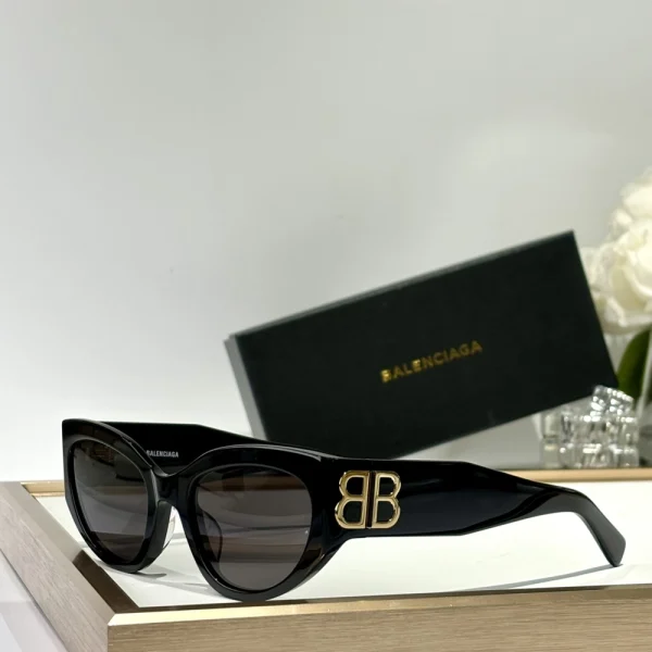 Close-up of Balenciaga Eyewear Bossy sunglasses featuring thick temples and glossy black finish