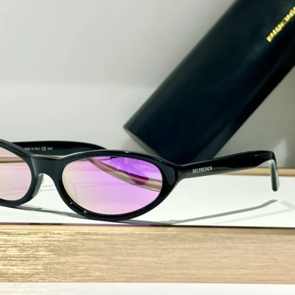 Model wearing Balenciaga Neo sunglasses with round frame, styled for a sleek, futuristic look