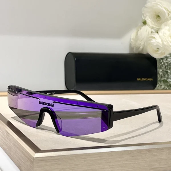 Close-up of Balenciaga Ski rectangle sunglasses showing sculpted frame and reflective lenses