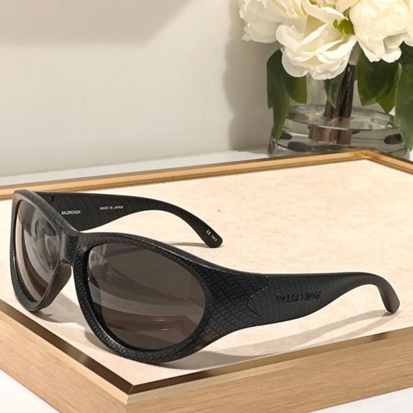 Close-up of Balenciaga Swift oval sunglasses crafted from lightweight acetate with engraved branding