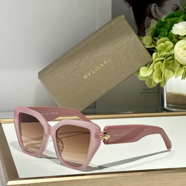Bvlgari Serpenti sunglasses styled on a neutral-toned fabric backdrop, capturing the snake-inspired side profile