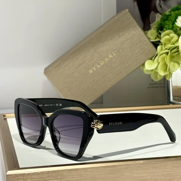 Luxurious Bvlgari Serpenti eyewear resting diagonally on a stone-textured surface, bold and refined