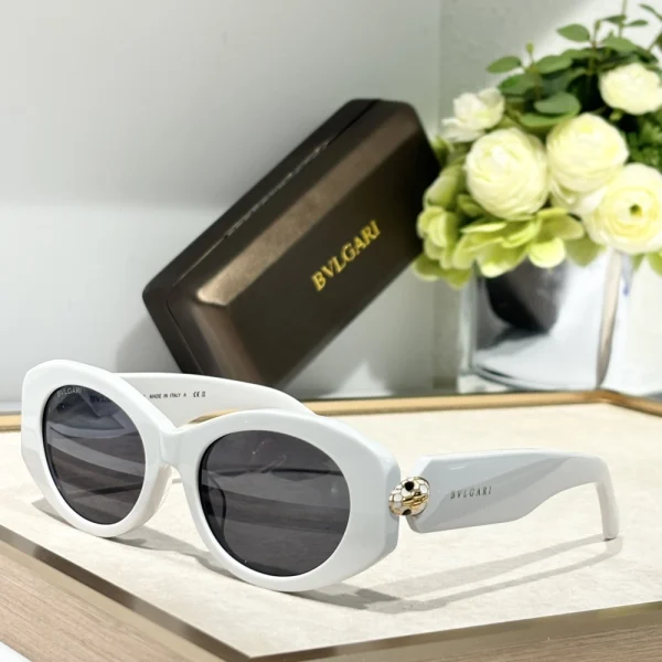 Model wearing Bvlgari Serpenti sunglasses styled with minimalist outfit for timeless elegance