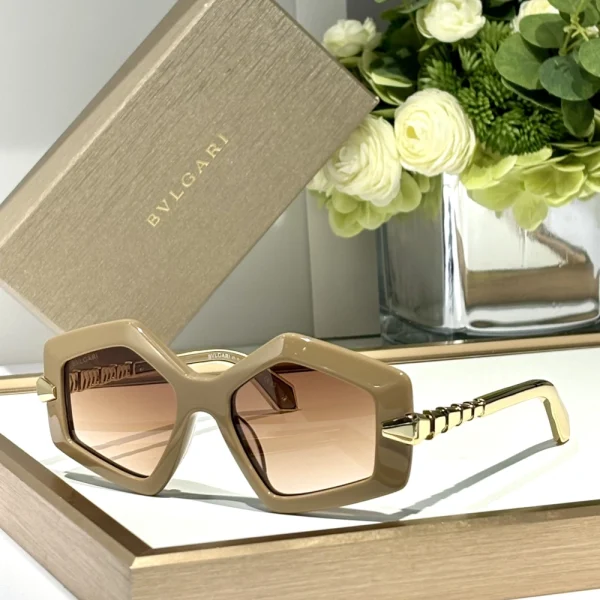 Bvlgari Serpenti sunglasses resting on a white surface, showcasing signature snake-scale detail on temples