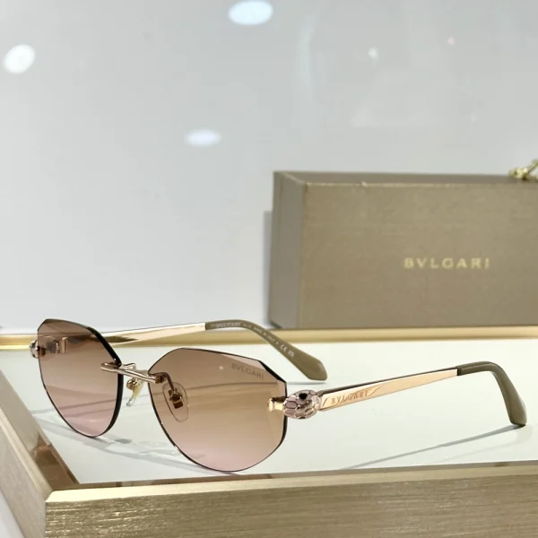 Sculptural Bvlgari Serpenti sunglasses in black and gold, combining bold elegance with serpent-inspired design