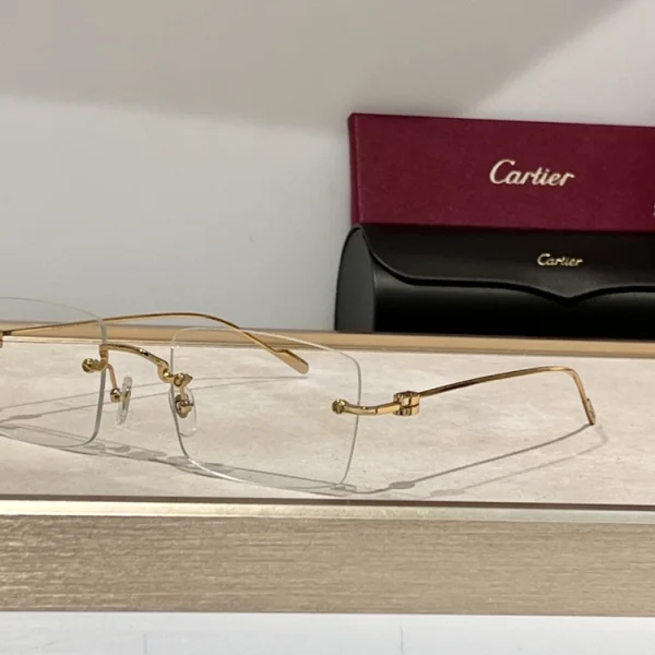 Luxury Cartier C de Cartier Precious Sunglasses resting beside red Cartier box, showcasing polished finish and iconic temple motif