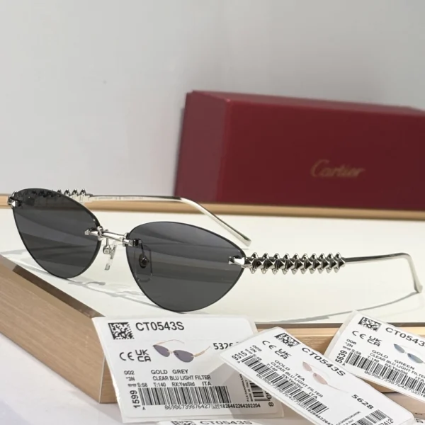 Edgy yet elegant Cartier Clash sunglasses, crafted in shiny gold-tone with dark tinted lenses