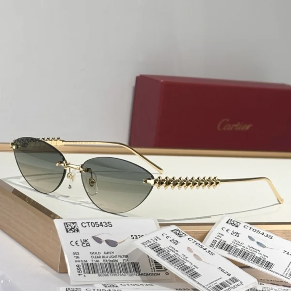 Cartier Clash sunglasses in flat lay with logo box and soft pouch, emphasizing luxury packaging