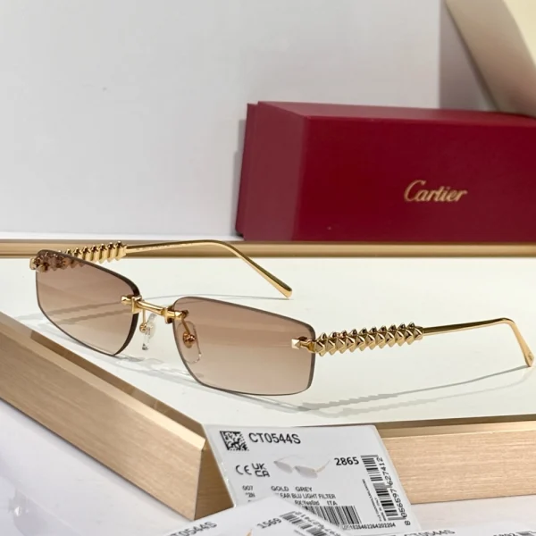Cartier Clash de Cartier sunglasses with squared frame and metal stud accents, photographed against a neutral stone background
