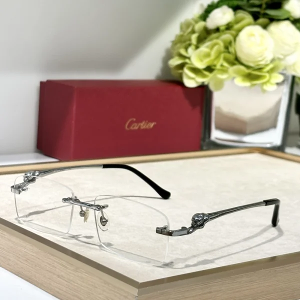Cartier Panthère de Cartier sunglasses resting on white marble, showcasing sculpted panther detail at the hinge