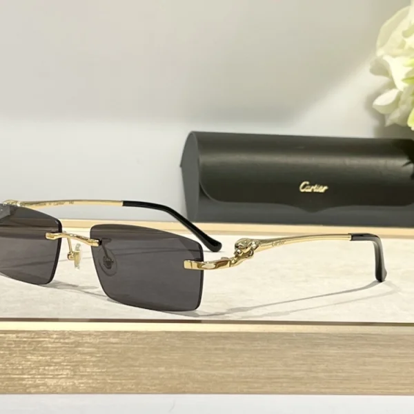 Close-up of Cartier Panthère de Cartier sunglasses with gold-tone panther accent and gradient lenses, placed on soft beige fabric