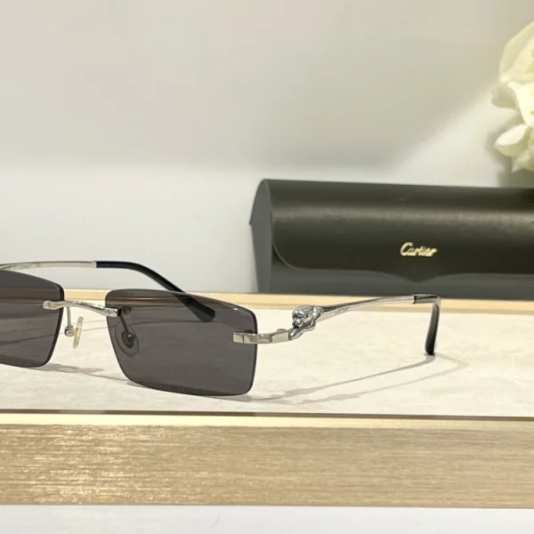 Cartier Panthère de Cartier sunglasses laid on a glossy table, highlighting premium craftsmanship and bold panther motif