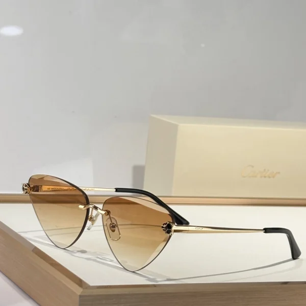 Cartier sunglasses resting on white surface with panther-head temples gleaming under soft light
