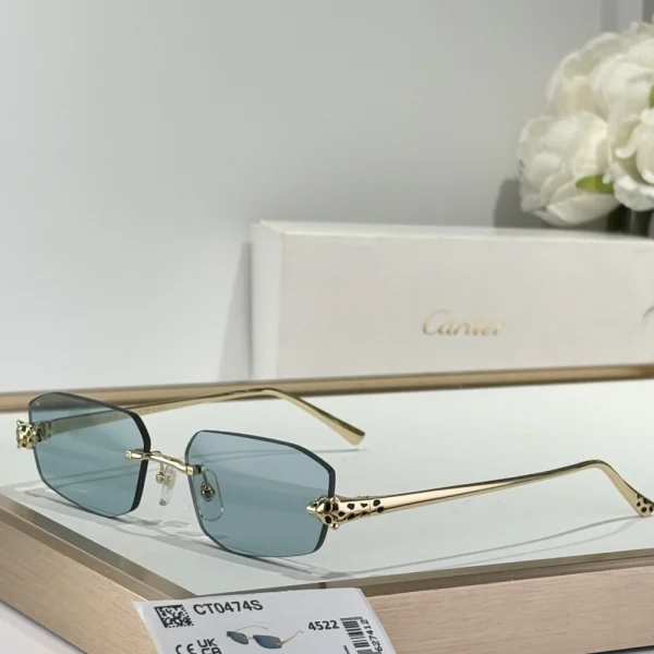 Cartier Panthère de Cartier sunglasses placed on a white glossy surface, showcasing the iconic panther detail wrapped around the temples