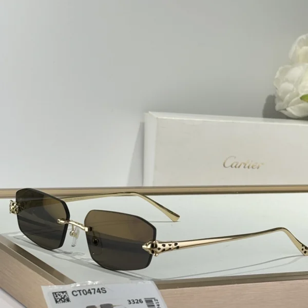 Luxury Cartier Panthère de Cartier sunglasses featuring sculpted feline design with emerald-tone eyes and deep black lenses