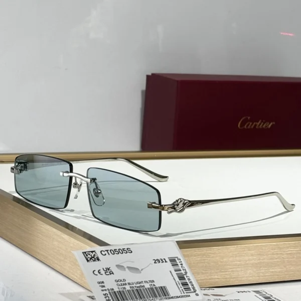 Cartier Panthère de Cartier sunglasses placed elegantly on a marble surface, highlighting the sculptural gold panther detail on the temples