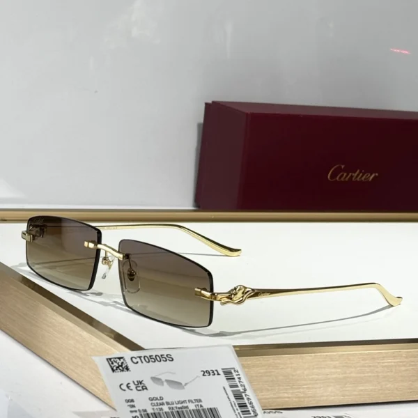 Close-up of Cartier Panthère de Cartier sunglasses with black gradient lenses and polished feline motif in brushed gold