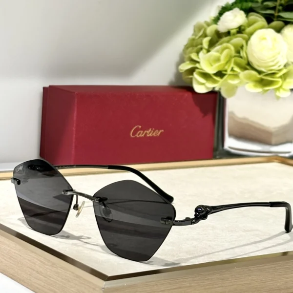 Cartier Panthère de Cartier sunglasses laid beside red Cartier case, emphasizing elegance and iconic design