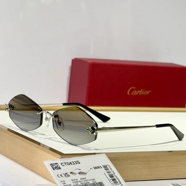Detailed shot of Panthère de Cartier sunglasses with faceted panther design and green gem-like eyes