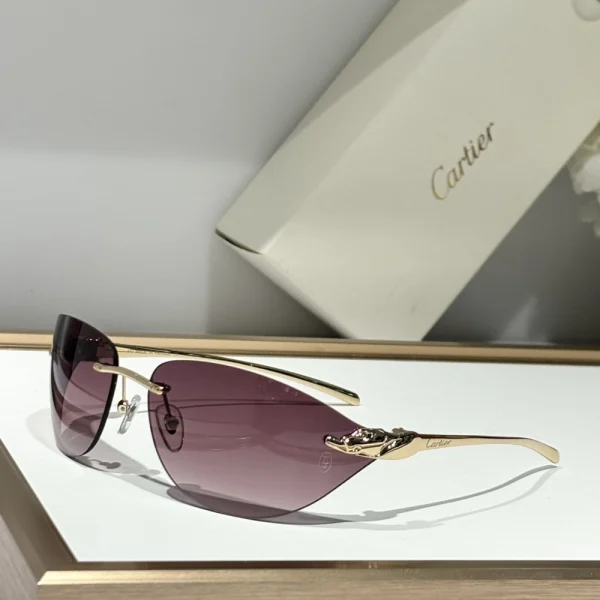 Cartier Panthère de Cartier sunglasses placed on a white tabletop with the signature red Cartier box in the background