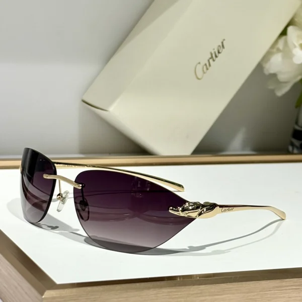 Cartier Panthère de Cartier sunglasses resting on a smooth surface, highlighting sleek black frame and sculpted feline motif