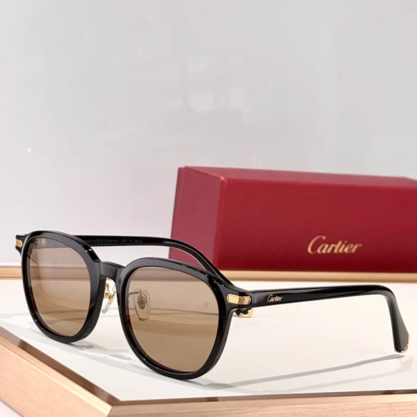 Cartier Première sunglasses resting on a white surface with red case and branded accessories