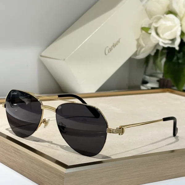 Elegant Cartier Première de Cartier sunglasses resting on a white table, showcasing luxury design and iconic silhouette