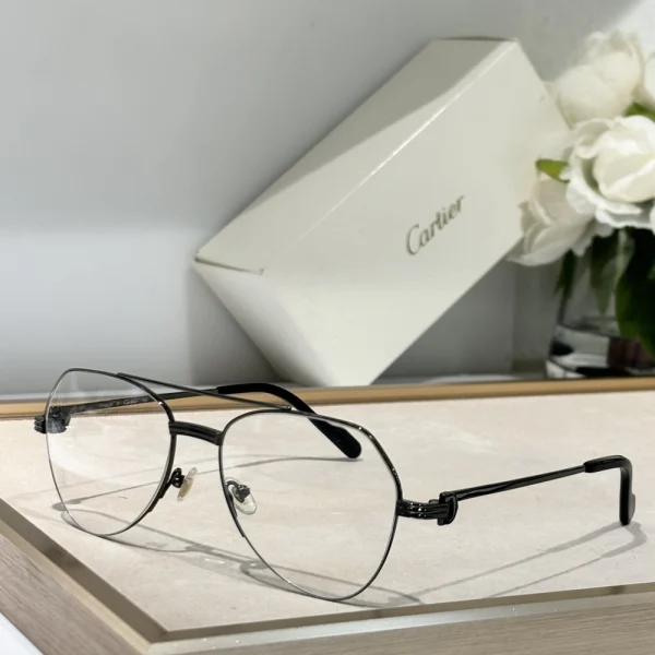Close-up of Cartier Première de Cartier sunglasses with polished black frame and gold-tone temples