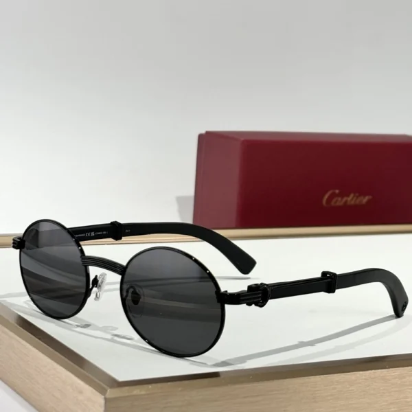 Cartier Première de Cartier sunglasses with slim gold temples and softly tinted lenses, resting on a beige linen surface