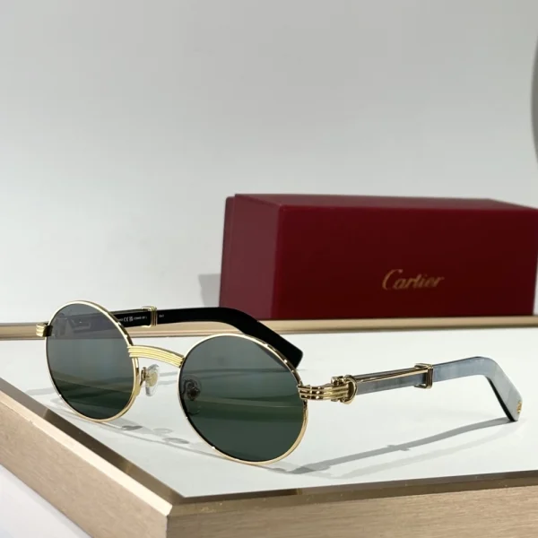 Cartier Première de Cartier sunglasses in shiny black finish with delicate metal accents, laid beside the red Cartier case